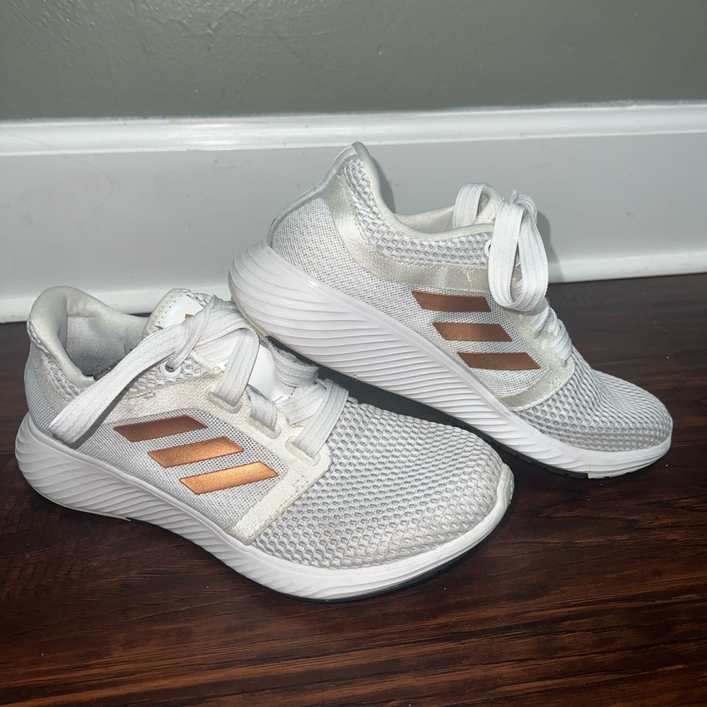 White running shoes adidas with copper lines